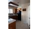 Functional kitchen featuring wood cabinets, black appliances, and neutral tile flooring at 5020 Wildroot Rd, Las Vegas, NV 89130