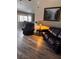 Cozy living room with wood floors and comfortable leather seating at 5020 Wildroot Rd, Las Vegas, NV 89130
