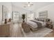 Serene bedroom featuring hardwood floors, neutral paint, and lots of natural light at 5120 Mirage Garden St, Las Vegas, NV 89130