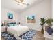 Bright bedroom showcasing a blue patterned rug, ceiling fan, and large windows at 5120 Mirage Garden St, Las Vegas, NV 89130