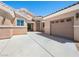 Front exterior view with desert landscaping, three car garage, and tile roof at 5120 Mirage Garden St, Las Vegas, NV 89130