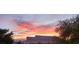 Dramatic pink sunset behind a roof line and trees creates a gorgeous silhouette at 5120 Mirage Garden St, Las Vegas, NV 89130