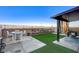 Backyard featuring green artificial turf, a covered patio, and mountain views at 5236 Sunstone Mesa Dr, Las Vegas, NV 89166