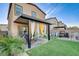 Landscaped backyard featuring a covered patio and artificial turf, perfect for outdoor living and entertaining at 5236 Sunstone Mesa Dr, Las Vegas, NV 89166