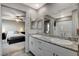 Bright bathroom showcasing double sinks, a large mirror, and a seamless transition to the bedroom at 5236 Sunstone Mesa Dr, Las Vegas, NV 89166
