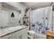 Bright full bathroom with a vanity, granite countertop, and a shower/tub combo at 5236 Sunstone Mesa Dr, Las Vegas, NV 89166