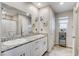 Bathroom featuring double sinks, a spacious granite countertop, and sleek fixtures at 5236 Sunstone Mesa Dr, Las Vegas, NV 89166