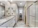 Bathroom featuring double sinks with granite countertops, tiled floors, shower, and bright lighting at 5236 Sunstone Mesa Dr, Las Vegas, NV 89166