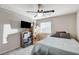 Comfortable bedroom with modern ceiling fan, flat screen TV, and natural light from the window at 5236 Sunstone Mesa Dr, Las Vegas, NV 89166