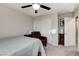 A cozy bedroom featuring a ceiling fan, neutral tones, and a comfortable bed beside a closet with sliding doors at 5236 Sunstone Mesa Dr, Las Vegas, NV 89166