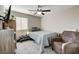 Cozy bedroom with a twin bed, ceiling fan, and a large window at 5236 Sunstone Mesa Dr, Las Vegas, NV 89166