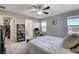 Comfortable bedroom features a closet, windows, and a compact desk near the bed, offering both space and functionality at 5236 Sunstone Mesa Dr, Las Vegas, NV 89166
