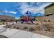 Neighborhood playground featuring a blue and red play structure with seating, situated near attractive, modern homes at 5236 Sunstone Mesa Dr, Las Vegas, NV 89166