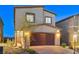 Two-story home with a two car garage and a desert landscape with a brick paver driveway at 5236 Sunstone Mesa Dr, Las Vegas, NV 89166