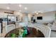 Open-concept kitchen and living area with a large island, stainless appliances, and modern decor at 5236 Sunstone Mesa Dr, Las Vegas, NV 89166