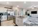 Spacious kitchen with granite island adjacent to a living area with a sofa and entertainment center at 5236 Sunstone Mesa Dr, Las Vegas, NV 89166
