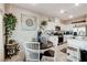 Bright kitchen with white cabinetry, stainless steel appliances, and a cozy dining area at 5236 Sunstone Mesa Dr, Las Vegas, NV 89166
