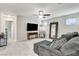 Upstairs living room with a plush sofa, a TV, and a mirror accent wall at 5236 Sunstone Mesa Dr, Las Vegas, NV 89166