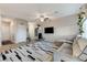 Living room with a sectional sofa, decorative furnishings, and lots of natural light at 5236 Sunstone Mesa Dr, Las Vegas, NV 89166