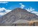 Spectacular view of community mountain peak showcasing the scale of this large desert mound, surrounded by metal fencing at 5236 Sunstone Mesa Dr, Las Vegas, NV 89166