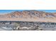 Expansive mountain views above a neighborhood of tile roofs and desert landscaping, a beautiful place to call home at 5236 Sunstone Mesa Dr, Las Vegas, NV 89166