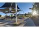 Community playground featuring covered play structures, slide, and walking path with mountain views at 5236 Sunstone Mesa Dr, Las Vegas, NV 89166