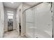 Bathroom featuring a glass-enclosed shower, tiled walls, and storage shelves, designed for functionality and style at 5236 Sunstone Mesa Dr, Las Vegas, NV 89166