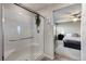 Modern bathroom with a glass-enclosed shower and views into the bedroom at 5236 Sunstone Mesa Dr, Las Vegas, NV 89166