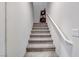 Carpeted stairs with a white handrail leading to the upper level at 5236 Sunstone Mesa Dr, Las Vegas, NV 89166