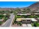 An aerial view of the houses in the neighborhood with a large mountain in the background at 532 Greenbriar Pl, Boulder City, NV 89005