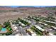 Aerial view of a well-manicured desert neighborhood, trees, desert landscaping and mountains at 532 Greenbriar Pl, Boulder City, NV 89005