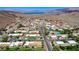 Panoramic aerial view of a neighborhood with desert landscaping, mountains, and a lake at 532 Greenbriar Pl, Boulder City, NV 89005
