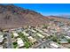 Aerial view of the neighborhood with mountains, landscaping, and a lake view at 532 Greenbriar Pl, Boulder City, NV 89005