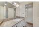 Bathroom featuring vanity with granite countertop and sink, large mirror, and tile flooring at 532 Greenbriar Pl, Boulder City, NV 89005
