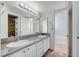 Bathroom featuring double sink vanity with granite countertops, large mirror, and tile flooring at 532 Greenbriar Pl, Boulder City, NV 89005