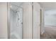 Bathroom shower with glass door and white tiled walls at 532 Greenbriar Pl, Boulder City, NV 89005