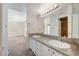 Bright bathroom featuring dual sinks with granite counters and a large mirror at 532 Greenbriar Pl, Boulder City, NV 89005