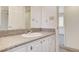 Vanity area with white sink and cabinet and gray countertop plus a large mirror at 532 Greenbriar Pl, Boulder City, NV 89005