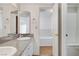 Bathroom featuring double sinks with granite countertops and white cabinetry at 532 Greenbriar Pl, Boulder City, NV 89005
