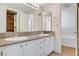 Bathroom featuring double sinks with granite countertops and white cabinetry at 532 Greenbriar Pl, Boulder City, NV 89005