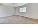 Spacious bedroom featuring neutral carpet, ceiling fan, and large window with blinds at 532 Greenbriar Pl, Boulder City, NV 89005