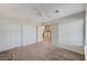 A bedroom with a ceiling fan, carpeted floors, and two doors leading to other rooms at 532 Greenbriar Pl, Boulder City, NV 89005