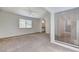 Spacious carpeted bedroom with ceiling fan and natural light from large window at 532 Greenbriar Pl, Boulder City, NV 89005
