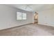 Primary bedroom featuring neutral carpet, large window and doorway access to the en suite bath at 532 Greenbriar Pl, Boulder City, NV 89005