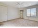 Bedroom featuring a ceiling fan, carpet floors, and a closet with shelves at 532 Greenbriar Pl, Boulder City, NV 89005