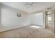 Large bedroom with ceiling fan, plush carpet, and a window providing natural light at 532 Greenbriar Pl, Boulder City, NV 89005