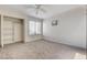 Bright bedroom with a window, ceiling fan, neutral carpet and open closet space at 532 Greenbriar Pl, Boulder City, NV 89005