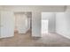 Bedroom with neutral carpet featuring open doors leading to other rooms at 532 Greenbriar Pl, Boulder City, NV 89005