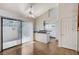 Open-concept dining room and kitchen with tile floors, white cabinets, and stainless appliances at 532 Greenbriar Pl, Boulder City, NV 89005