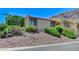 A well-maintained home with lovely desert landscaping and gorgeous mountain views in the background at 532 Greenbriar Pl, Boulder City, NV 89005